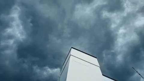 Minimalist White Building Under Dramatic Stormy Sky Stock Photos