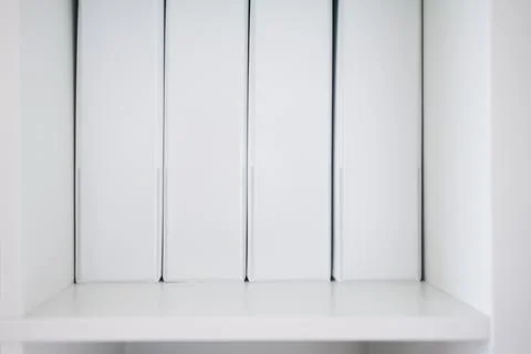 Minimalist white document binders on white bookshelf, sleek office organizati Stock Photos