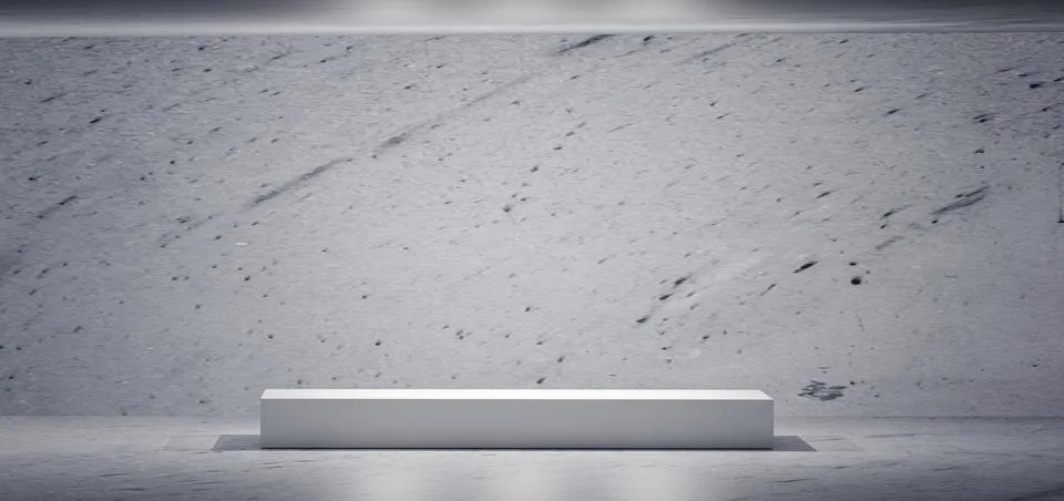 Minimalist white rectangular podium on a grey concrete wall and floor, lit .. Foto stock