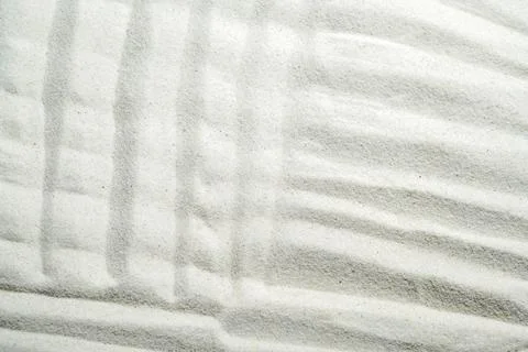 Minimalist white sand texture featuring raked Zen garden patterns with clea.. Stock Photos
