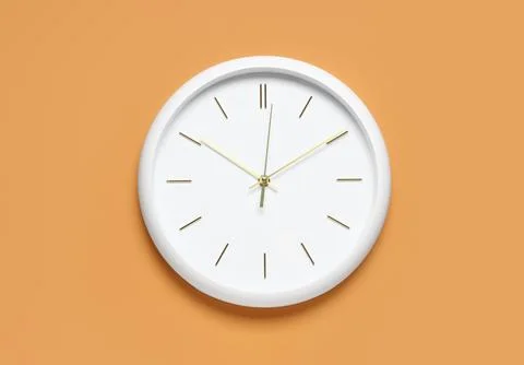 Minimalist white wall clock on orange background Stock Photos