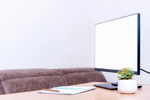 Minimalist workspace setup featuring a blank computer monitor, notebook wit.. Foto stock