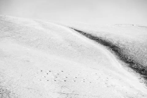 Minimalistic, almost empty view of snow in the mountains, with some barely Stock Photos