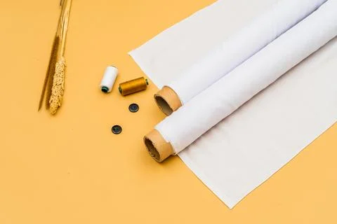 A minimalistic backdrop emphasizes the versatility of a white fabric roll i.. Stock Photos