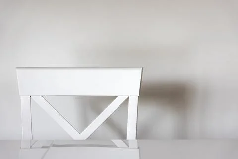Minimalistic background with a white chair at the table in the kitchen. Stock Photos