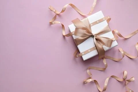 Minimalistic background with a wrapped gift Stock Photos