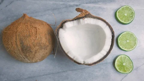 Minimalistic Coconut Flat Lay Animation on a Marble Table with Limes in 4k Stock Footage 90070916