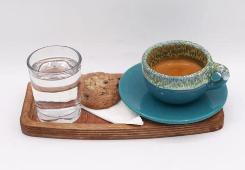 Minimalistic coffee serving scene with a cup of espresso, a glass of water Stock Photos