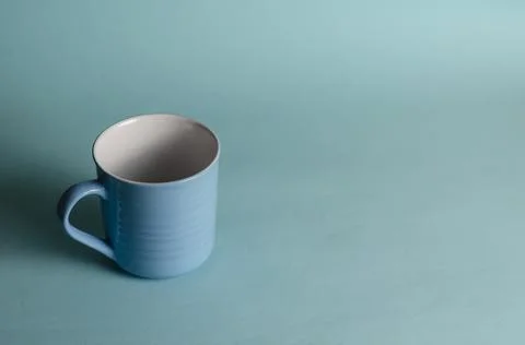 Minimalistic composition of a blue cup on a light blue background. New empty  Stock Photos