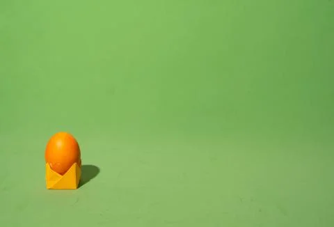 Minimalistic composition of easter egg on paper origami stand. Place for text Stock Photos