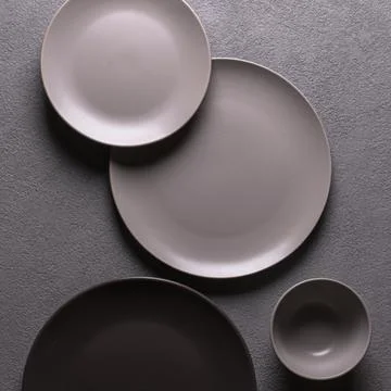 Minimalistic composition of plates and cups in gray, square flatlay photo Stock Photos