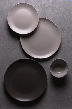 Minimalistic composition of plates and cups in gray color, vertical flatlay Stock Photos