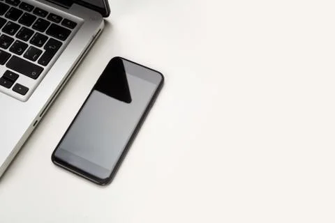 Minimalistic composition top view on white wooden table with laptop and mobil Stock Photos