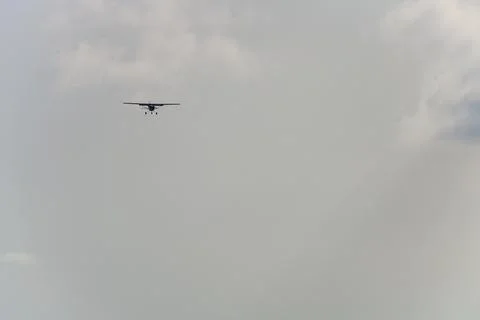 Minimalistic distant view of an airplane against the grey sky, Newcastle Aero Stock Photos