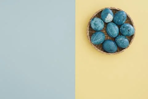Minimalistic easter background with blue easter eggs in basket with place for Stock Photos