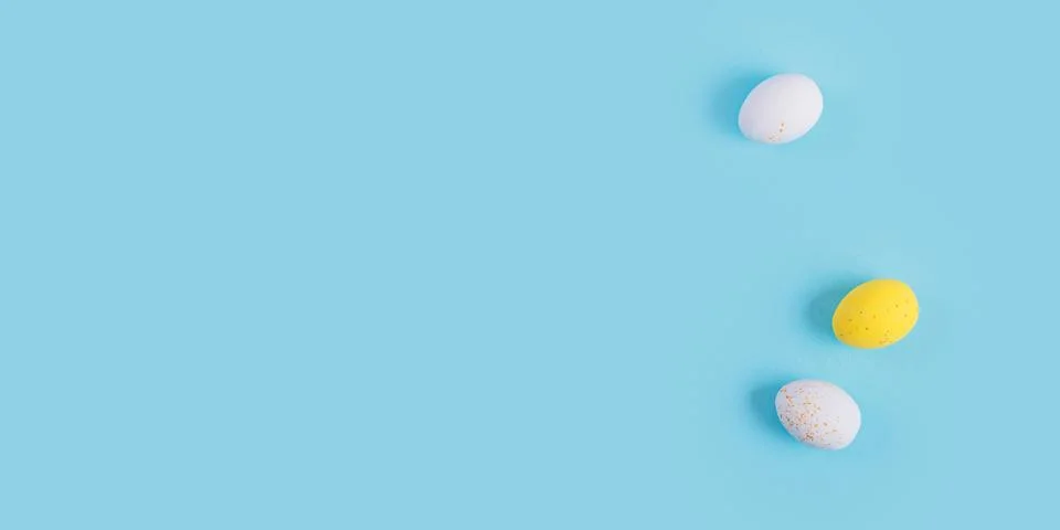 Minimalistic easter background of chocolate candy yellow and white eggs Stock Photos