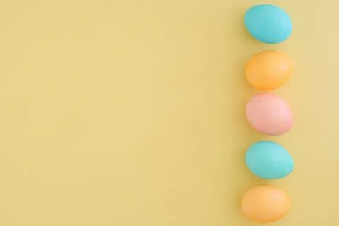 Minimalistic easter background with easter colorful eggs in pastel shades on Stock Photos