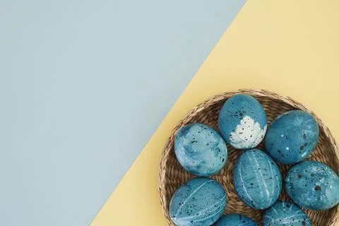 Minimalistic Easter composition of stylish blue Easter eggs in a basket on a Stock Photos