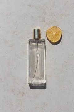 Minimalistic flat lay composition of a perfume bottle on a neutral background Stock Photos