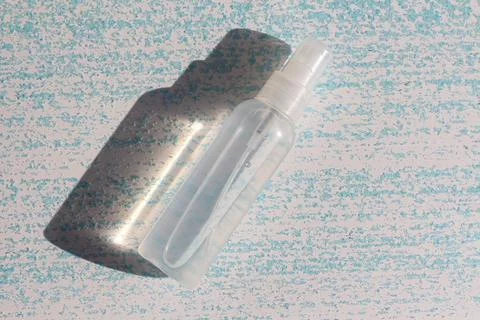 Minimalistic flat lay composition of a plastic transparent spray bottle Stock Photos