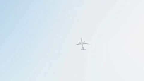 Minimalistic image of an airplane flying high in the clear blue sky with am.. Stock Footage 266387873