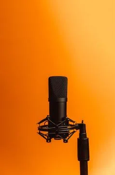Minimalistic image of a streaming microphone over an orange background with.. Stock Photos