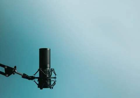 Minimalistic image of a streaming microphone over an pastel blue background.. Stock Photos