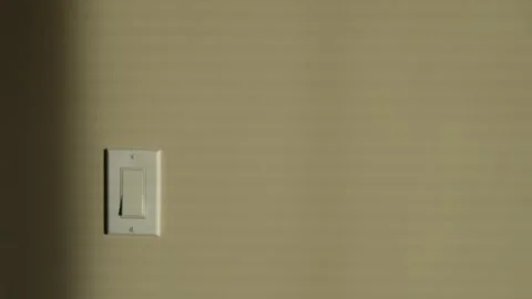 Minimalistic Light Switch on a Textured Beige Wall Stock Footage 263927855