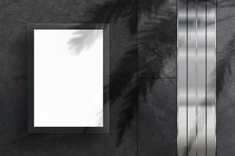 Minimalistic mockup with a blank vertical frame on a dark wall with palm tree Stock Photos