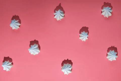Minimalistic pattern of meringue with a hard shadow on colored background Stock Photos
