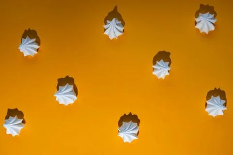 Minimalistic pattern of meringue with a hard shadow on colored background Stock Photos