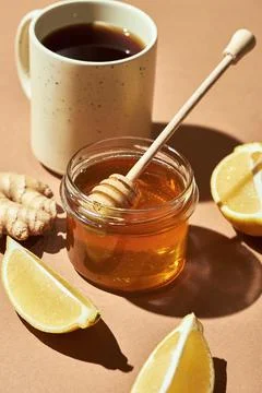 Minimalistic poster - composition with tea, lemon, honey and ginger on a brow Stock Photos