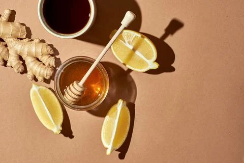 Minimalistic poster - composition with tea, lemon, honey and ginger on a brow Stock Photos