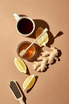 Minimalistic poster - composition with tea, lemon, honey and ginger on a brow Stock Photos