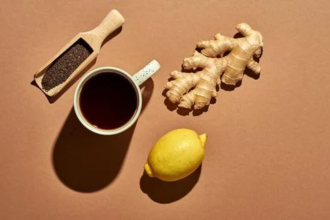 Minimalistic poster - composition with tea, lemon, honey and ginger on a brow Stock Photos