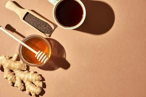 Minimalistic poster - composition with tea, lemon, honey and ginger on a brow Stock Photos