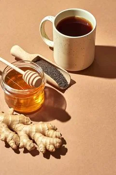 Minimalistic poster - composition with tea, lemon, honey and ginger on a brow Stock Photos