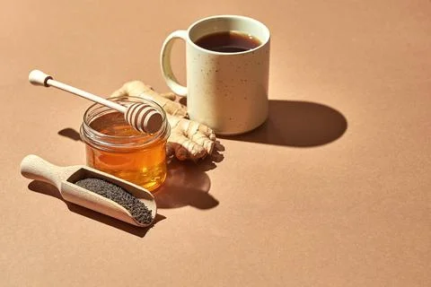 Minimalistic poster - composition with tea, lemon, honey and ginger on a brow Stock Photos