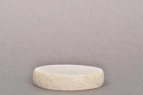 Minimalistic scene of a lying stone on a gray background. Podium for the pres Stock Photos
