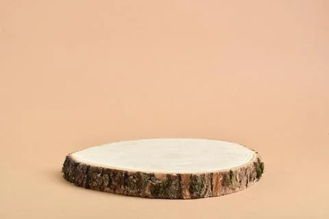 A minimalistic scene with a tree cut on a beige background. Podium for the pr Stock Photos