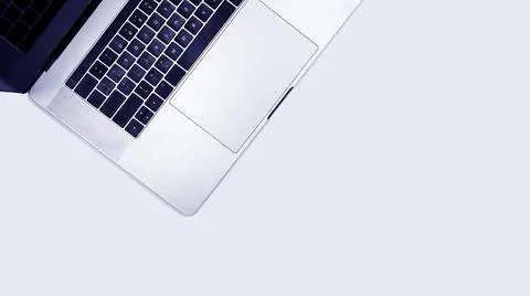 Minimalistic silver laptop on gray background with copy space, clean background Stock Photos