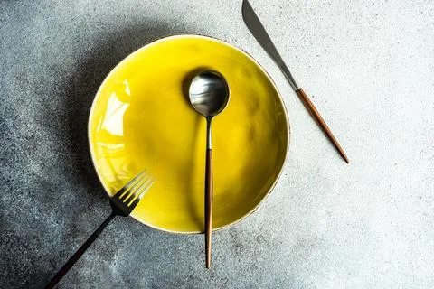 Minimalistic table setting with plate and cutlery Stock Photos