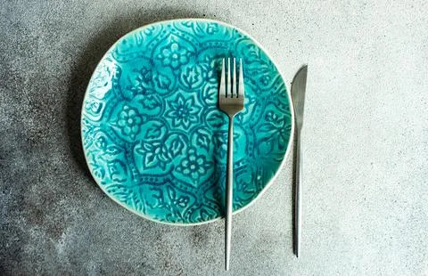 Minimalistic table setting with plate and cutlery Stock Photos
