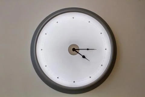 Minimalistic Wall Clock Showing Five O'Clock Stock Photos