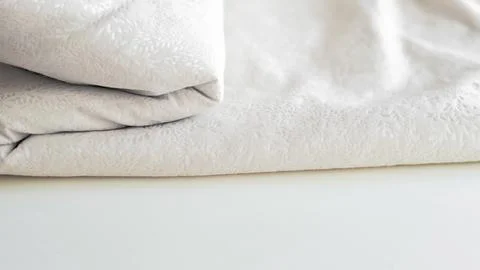 Minimalistic white crumpled fabric with pattern Stock Photos