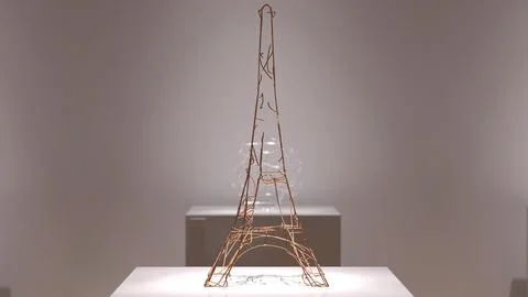 Minimalistic wire sculpture of the Eiffel Tower on a white pedestal in a mo.. Stock Illustration