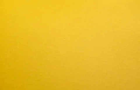 Minimalistic yellow background with a textured surface and smooth gradient .. Stock Photos
