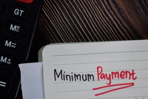 Minimum Payment write on a book isolated wooden table. Stock Photos