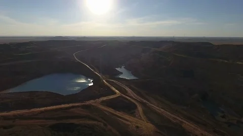 Mining boom. Excavator loads ore.Panorama. Artificial lake. Sunset. Development 動画素材 73434662