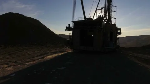 Mining boom. Excavator loads ore.Panorama. Artificial lake. Sunset. Development Stock Footage 73437356